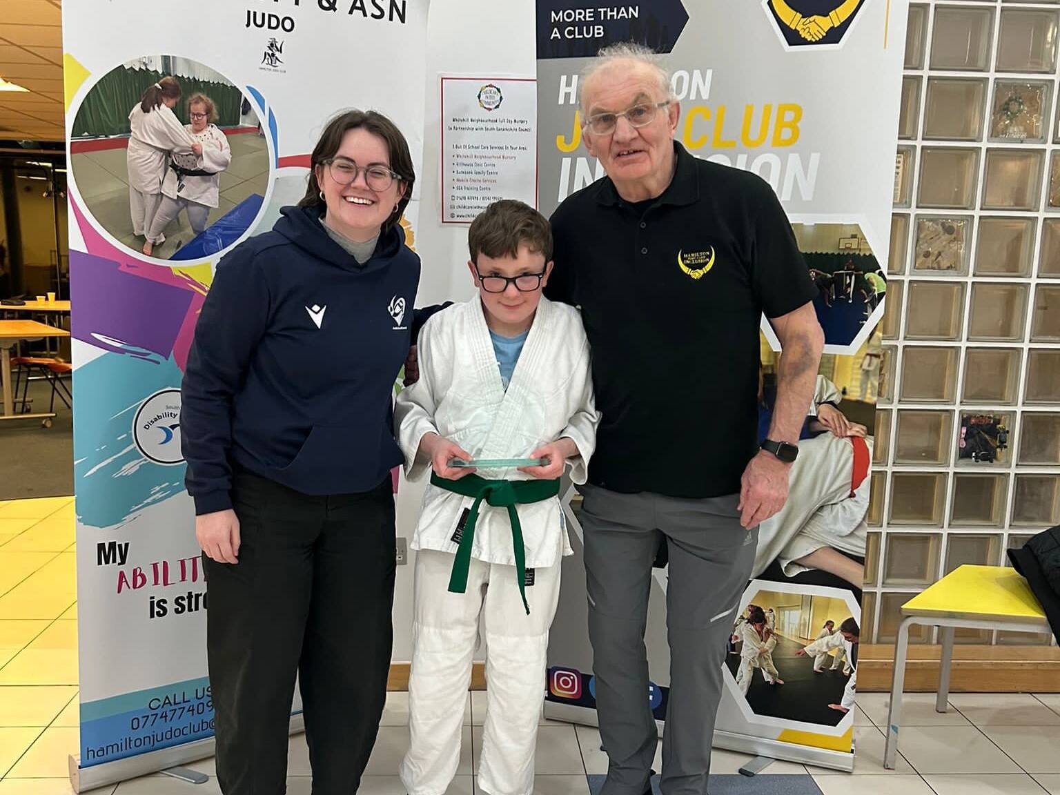 Daniel being presented his awardd by laura Kirkhouse and John Kane