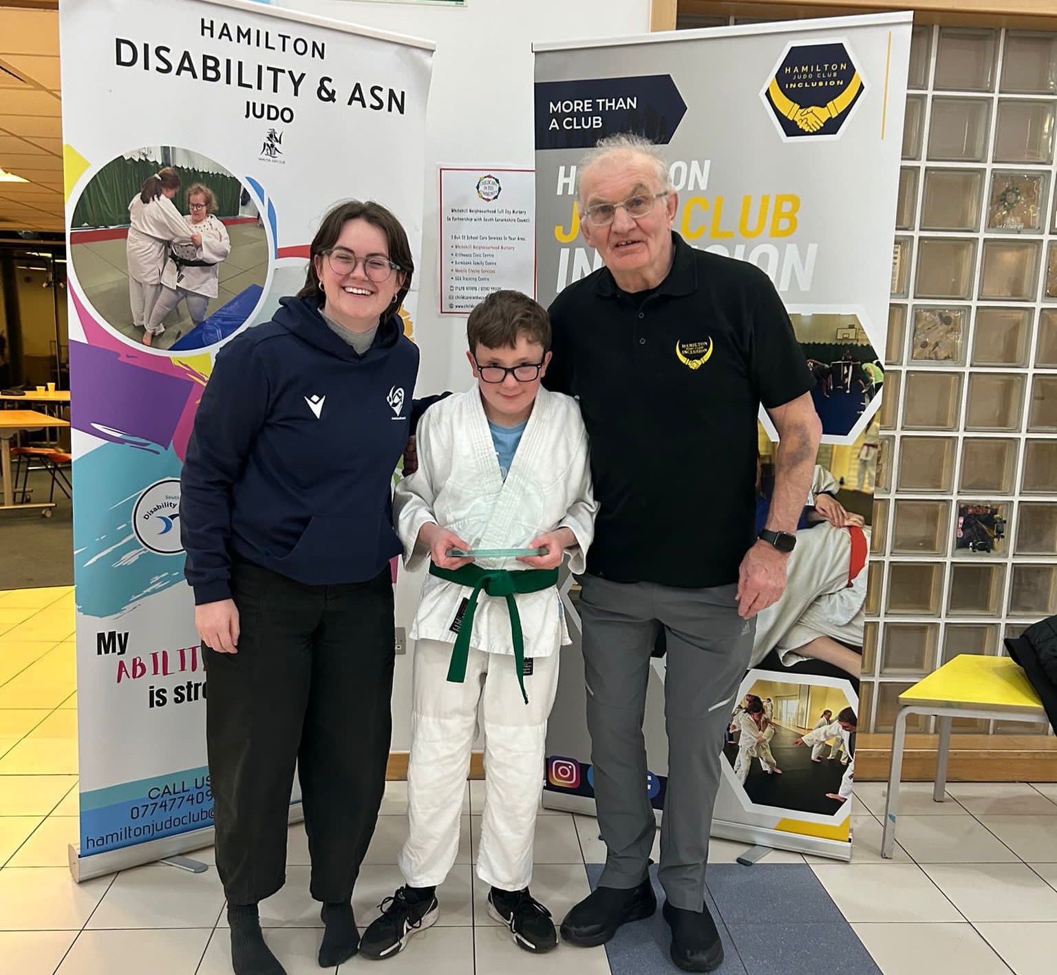 Daniel being presented his awardd by laura Kirkhouse and John Kane