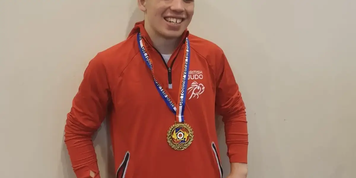 Murray McConnell proudly shows off his medal wearing his GB tracksuit