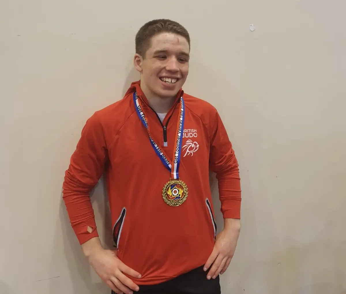 Murray McConnell proudly shows off his medal wearing his GB tracksuit